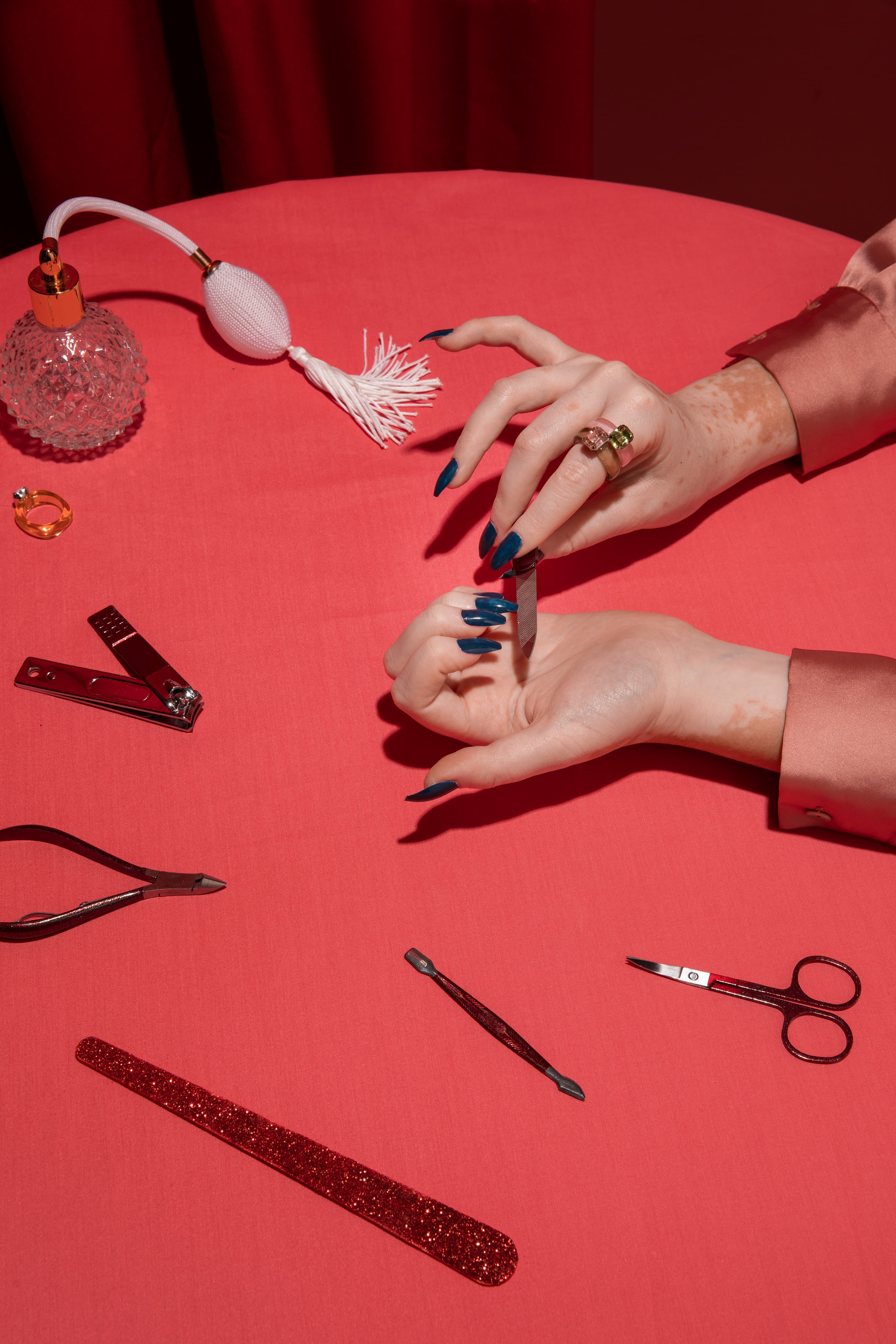 Client selecting nail colour on phone with fresh manicure